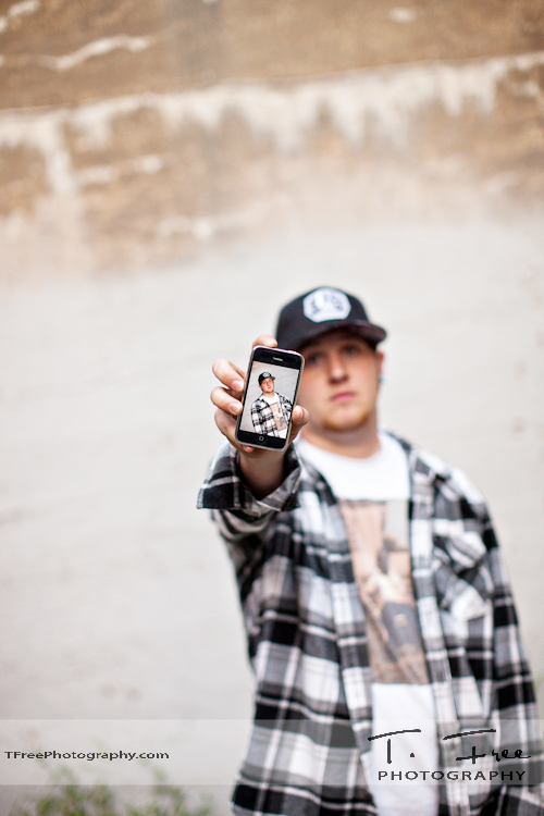 Urban grunge holding iphone shot in downtown Omaha Nebraska.