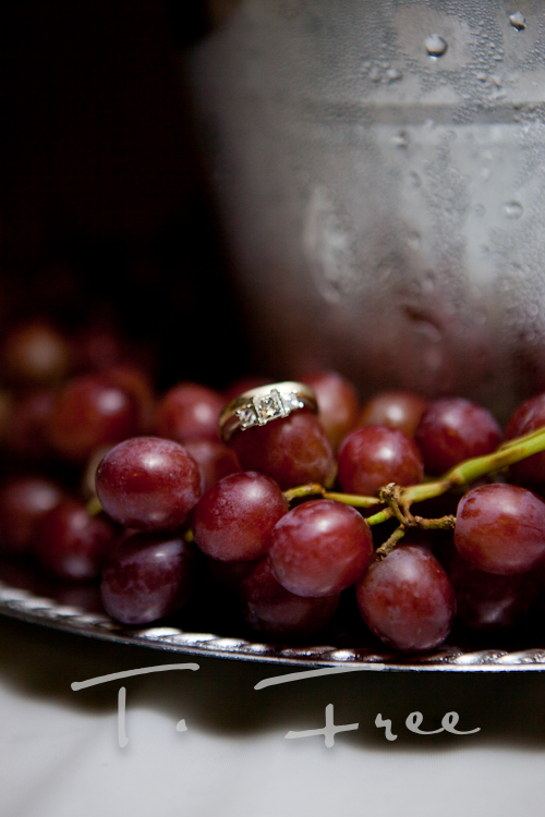 Wedding ring photo with red grapes at Nebraska vineyard.