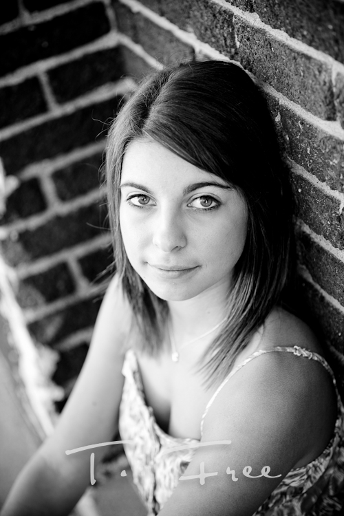 Outdoor black and white close up image of high school senior girl taken in north downtown Omaha, Nebraska.